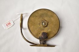 A Brass replica sidecasting fishing reel measuring 4 inches diameter marked Mallochs patent & Strand