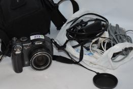 A Canon Powershot S3 IS digital camera with charger, disc and booklet, in soft camera bag
