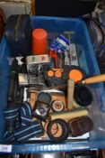A box of various dark room and photography equipment including lightmeters, film loader,