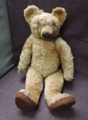 A 1930's /40's Chad Valley straw filled yellow plush Teddy Bear having replacement button eyes,