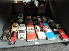A shelf of playworn diecasts including 1:18 scale Maisto 1971 Chevrolet Chevelle and Jaguar MKII,