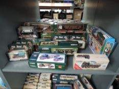 A shelf of Corgi Eddie Stobart diecasts including 23101, 97369, 31704, 59502 etc 16 in total along