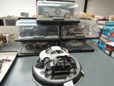 Seven Franklin Mint 1:24 scale diecasts, 1967 Volkswagen Beetle, 1998 Volkswagen New Beetle, 1929