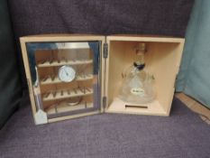 A Hennessy Cognac wooden and circular Cave a' Cigares Humidor containing empty glass bottle,