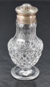 A George V silver topped and mounted cut-glass sugar sifter, the associated pierced pull-off cover