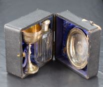 An Edwardian cased silver three-piece travelling communion set, comprising chalice, paten and silver