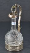 A late Victorian electro-plated bottle/decanter stand, having a scrolled acanthus and lion mask