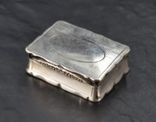 A George III silver snuff box, of hinged rectangular form, the cover with shaped outline and foliate