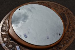 A vintage teak frame wall mirror