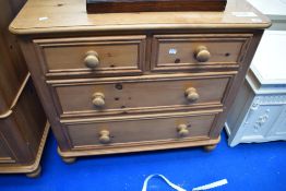 A modern natural pine chest of two over two drawers