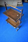 An early 20th Century oak cake stand