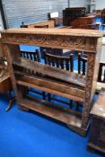 An early 20th Century oak open bookshelf having carved detailing