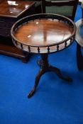A reproduction wine table having spindle gallery