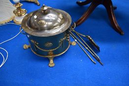 A vintage brass coal bucket and fire tools