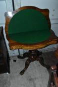 A 19th Century walnut and mahogany fold over card table having shaped top, column base and quadruple