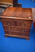 A reproduction Regency dwarf chest of two over two drawers, with brushing slide