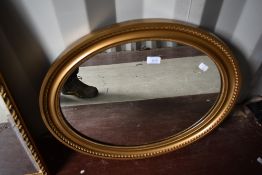 A vintage gilt frame oval wall mirror