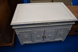 A vintage painted blanket box having lift lid