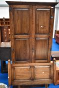 A mid to late 20t Century oak wardobe and headboard