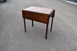 An Edwardian mahogany pembroke table having line and shell inlay decoration