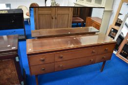 A vintage teak effect dressing table
