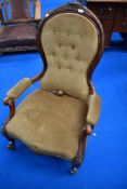 A 19th Century easy chair having scroll frame and button back dralon upholstery