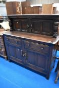 A vintage dark stained Ercol or similar court cupbpard