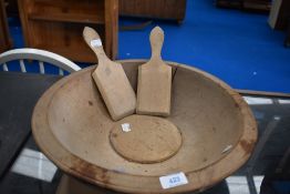 An antique sycamore butter bowl, diameter 40cm, with some damage and a pair of similar butter pats/