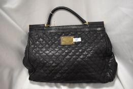 A quilted black leather handbag or larger proportions, bearing the Dolce and Gabbana label to