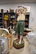 A 1930s chalkware study; boy with cherries, AF.