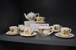 An early 20th century dolls tea service, having nursery rhyme transfer patterns to each piece,
