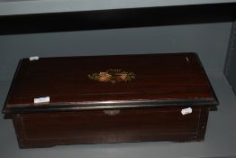 A 19th Century mahogany cased music box, having 8 airs, the pictorial card having hand written