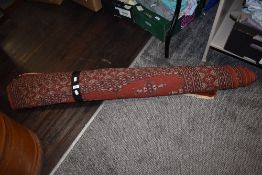 A traditional North west Persian rug, of Bokhara design, using burnt red, cream and black tones.