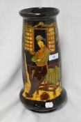 A 20th century brown moulded vase, having depiction of traditionally dressed gent leaning against