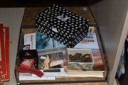A variety of items of military interest, including a box of buttons, books and badges.