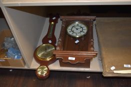 A reproduction wall clock and a mid century barometer.