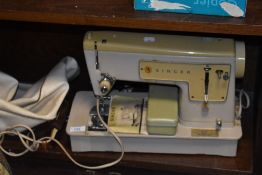 A 1960s Singer 449 sewing machine, with manual, pedal and case.