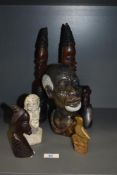 A selection of African carved wood and natural stone busts.