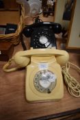 Two mid century rotary dial telephones.
