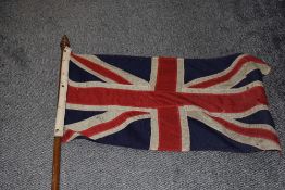 An antique Union flag on wooden pole, AF.