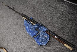 A Daiwa carbon 2pc whisker rod and an unmarked 2pc surf rod both in soft cases