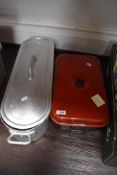 A vintage salmon poaching pan and a Hardy Smoker fishermans cooking aid.