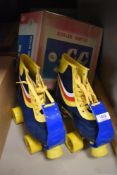 A pair of childrens roller skates size 34