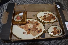 A group of three pressed flower compositions, displayed within oval brass frames, signed Christine