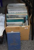 A box of maritime themed books and publications, including 'The Art of Nautical Illustration', '