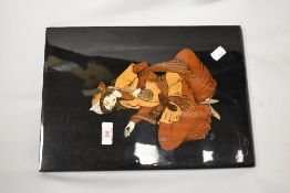 A 20th Century Persian inspired wall plaque, depicting a seated lady, and measuring 24cm x 34cm