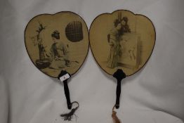 A pair of late 19th Century Japanese hand held silk fans, with ebonised handles, measuring 34cm