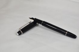 A Montblanc Meisterstuck 144 converter fountain pen in black with platinum plated trim having a