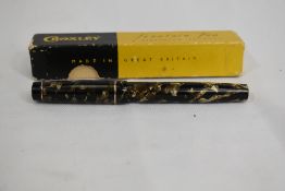 A boxed Croxley lever fill fountain pen in black grey marble with single narrow band to cap having