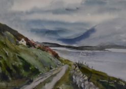E.M Audigier (20th Century), a watercolour, A remote lake scene with track leading towards houses,